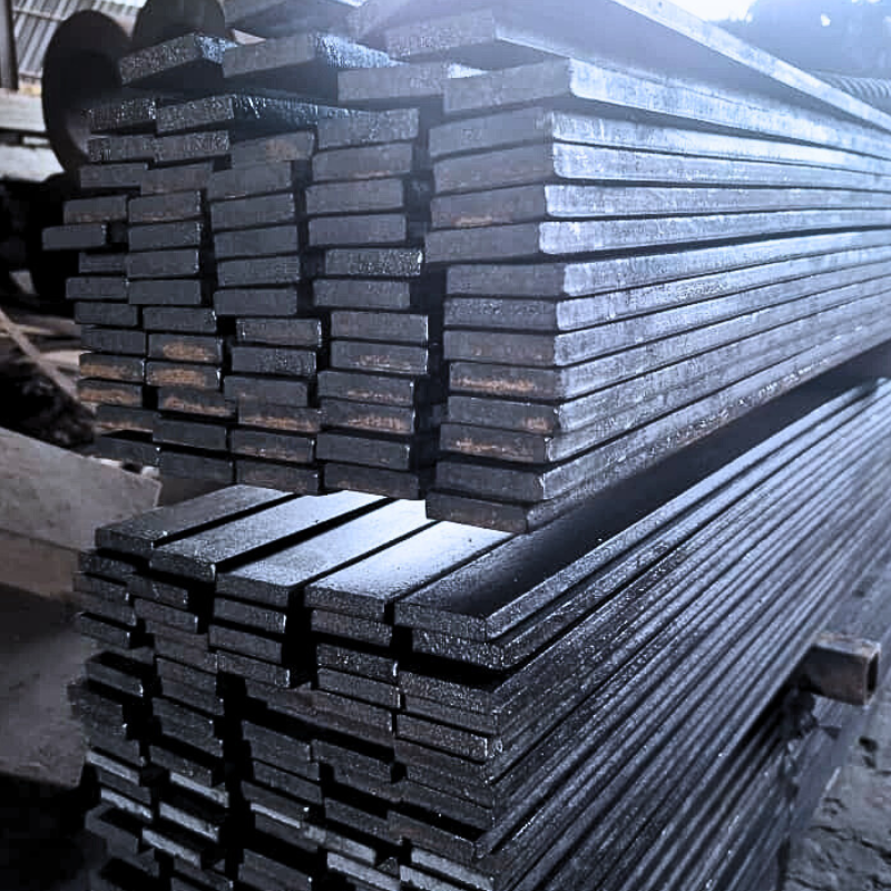 Close-up of stacked metal bars in warehouse